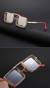 Gros plan sur lunettes steampunk avec monture dorée évidée et branches rouges