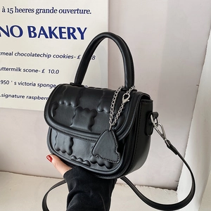Fashionable black embossed leather handbag with wave pattern and silver chain strap