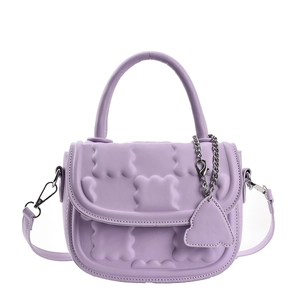 Chic purple crossbody bag with unique bubble texture and round handle on white background