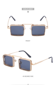 Détail de lunettes steampunk avec monture ajourée dorée et verres gris fumés