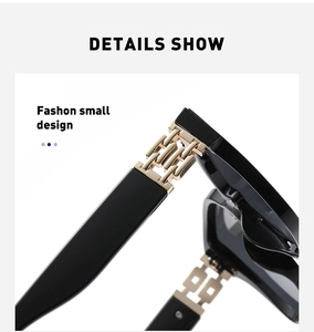 Detail shot of black sunglasses featuring a decorative golden metal chain design on the temple