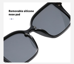 Detailed macro view of the removable silicone nose pad on square black sunglasses