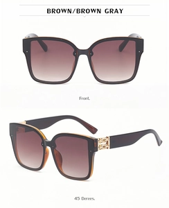 Detail of square sunglasses with brown gradient lenses and gold chain hinge decor