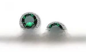 Macro view of halo stud earring featuring a large green round-cut zircon and silver base