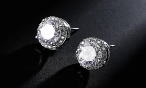 Macro shot of round-cut AAA zircon stud earrings with sparkling halo and silver setting