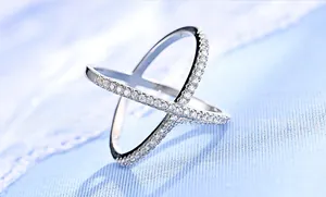Macro detail of silver double cross ring featuring sparkling cubic zirconia pave setting
