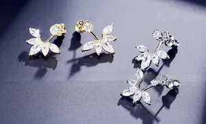 Detailed view of gold and silver fan-shaped stud earrings with marquise-cut cubic zirconia
