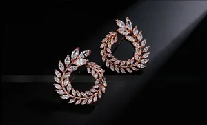 Detail of rose gold olive branch earrings featuring sparkling marquise cut cubic zirconia