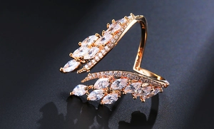 Macro shot of gold angel wing ring featuring marquise-cut cubic zirconia feathers