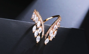 Macro detail of rose gold angel wing ring with marquise-cut zircons and pavé diamonds