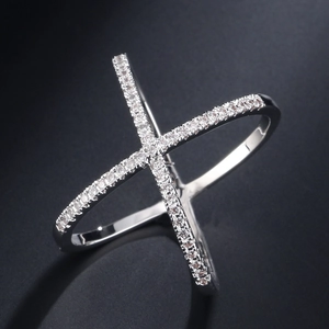 Cross-layered zircon ring with X-shape silver finish on a textured grey background
