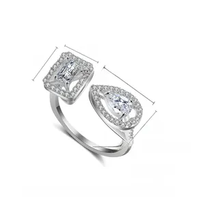 Macro view of geometric open ring with cubic zirconia pear and rectangle stones