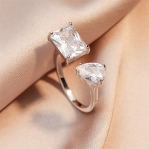Detail of silver adjustable ring with rectangular and pear-cut cubic zirconia stones