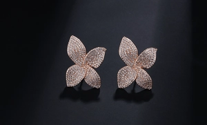 Macro view of flower stud earrings featuring rose gold petals with micro-pave zircons