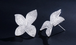 Macro shot of silver butterfly stud earrings with sparkling pavé cubic zirconia