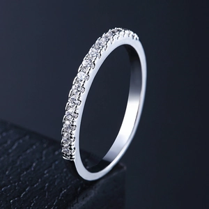 Macro view of silver half-eternity ring with micro-paved sparkling AAA cubic zirconia