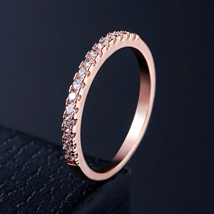 Detail shot of rose gold band featuring white cubic zirconia pavé setting on a dark base