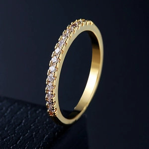 Macro side view of a gold-finished ring with a half-circle of sparkling AAA cubic zirconia