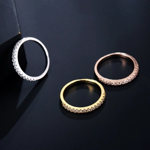 Detailed view of adjustable ring set in silver, gold, and rose gold with AAA zircon stones