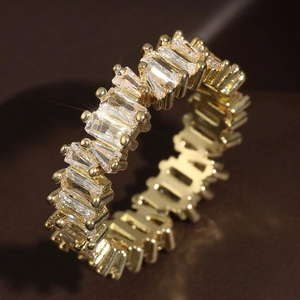 Eternity ring with baguette cut cubic zirconia in 18K gold plated copper base