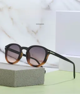 Detail of trendy punk sunglasses with black to coffee gradient frame and silver arrow decor