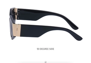 Side view of wide black acetate sunglasses with large decorative gold metal hinges