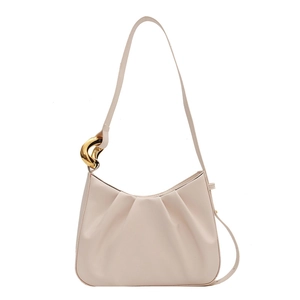 Chic beige pleated bucket bag with stylish gold chain strap detail on white background