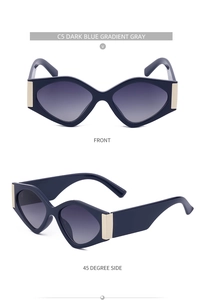 Close-up of dark blue cat-eye sunglasses with gradient gray lenses and gold accents