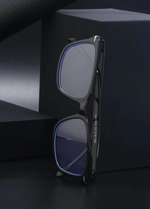Macro detail of model DB1063 black square frame glasses showing temple specs and hinges
