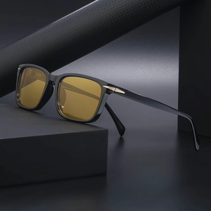 Black square sunglasses with yellow lenses and gold arrow hinges for outdoor driving