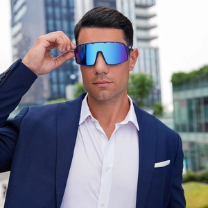 Close-up of blue mirrored lens cycling sunglasses worn by a male model in city setting
