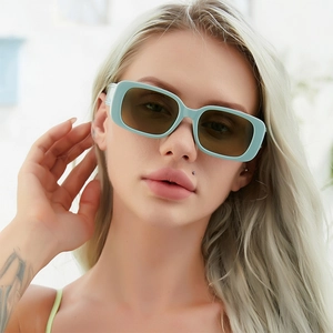 Close-up of rectangular sunglasses with mint green frames and brown tinted lenses