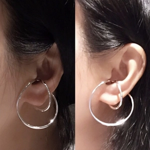 Minimalist double layer silver Mobius ear cuff showing a non-piercing style fit
