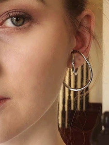 Silver Mobius ear cuff detail on model showing double minimalist geometric layered rings