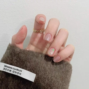 Dettaglio macro di anello a onda in oro con diamanti e nail art con fiocchi di neve