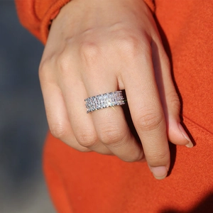 Close-up of luxury double-row pear-cut zircon ring in silver finish on hand