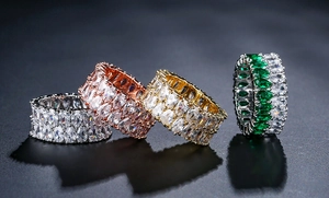 Macro shot of luxury double-row pear-cut cubic zirconia eternity rings in multiple finishes