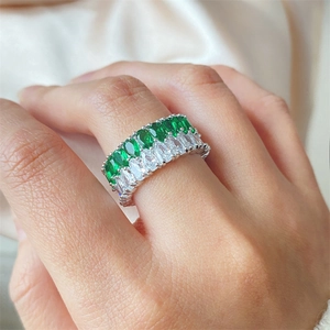 Luxurious double-row marquise zircon ring with green and white stones on silk background