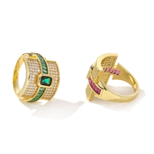 Detail view of gold rings with emerald-cut green gems and micro-paved zircons