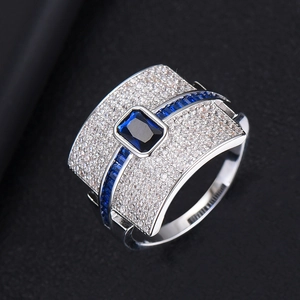 Macro detail of silver ring featuring deep blue stones and sparkling pave zircons