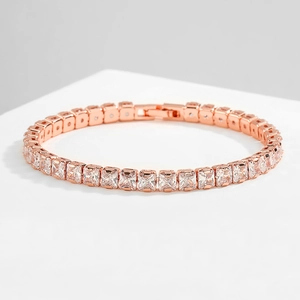 Close-up of rose gold tennis bracelet with square-cut cubic zirconia in four-prong setting