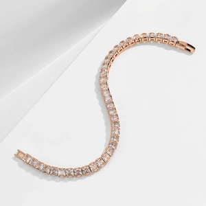 Macro shot of rose gold tennis bracelet with square-cut cubic zirconia in S-curve pose