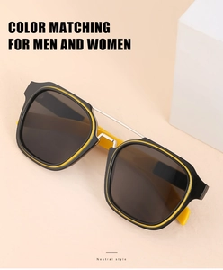 Detail of retro oversized sunglasses with yellow and black contrast frame and metal bridge