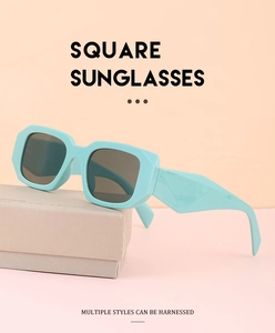 Detail of mint green square sunglasses with geometric temple on pink background