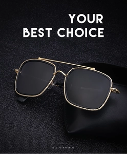 Detail of vintage gold metal frame sunglasses with textured edges and dual bridge design