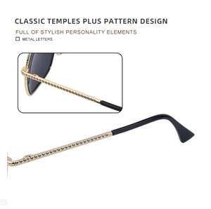 Macro detail of golden metal temples with engraved textures on square frame sunglasses