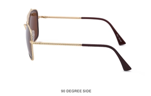 Detail view of gold aviator sunglasses with textured metal frames and brown lenses