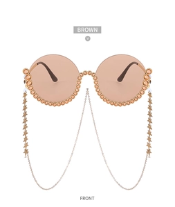 Nahaufnahme der runden Vintage-Sonnenbrille mit Goldrahmen, Strass und Sternenkette