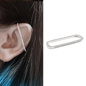 Detail of silver rectangular ear cuff with cubic zirconia on model and white background