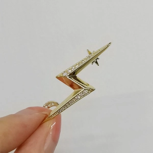 Macro shot of a gold lightning bolt ear cuff with sparkling zircon inlay details